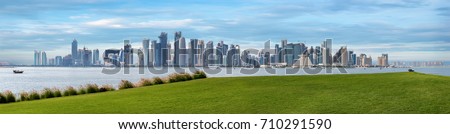 The skyline of Doha, Qatar, on a hazy spring day seen from the MIA Park Royalty-Free Stock Photo #710291590