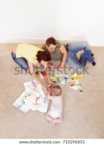 Young family on floor with color samples