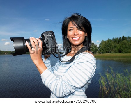 Woman taking pictures, smiling