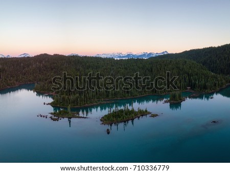 Aerial panoramic landscape view of the beautiful rocky islands in glacier lake with mountains in the background. Picture taken in Garibaldi near Squamish, North of Vancouver, British Columbia, Canada.