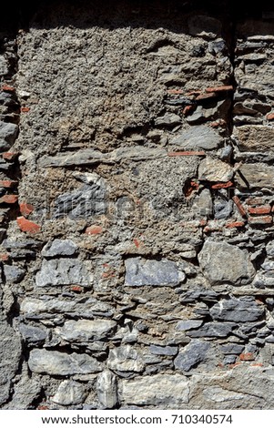 an old broken wall on the facade of an old house in a sunny day
