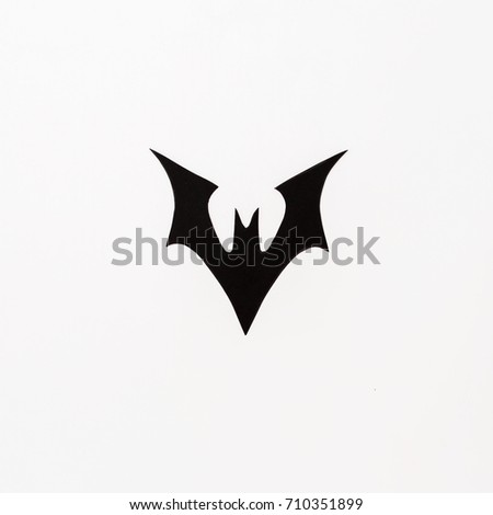Handmade black paper bats for Halloween holiday on white background. Flat lay, top view.