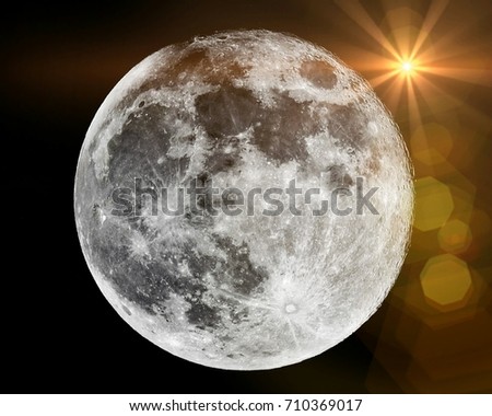 Close up of full moon with sunlight flare seen with the telescope from northern hemisphere. Showing detail of moon surface. Isolated background.
