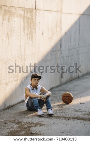 Young Man Holding a Basketball Ball
