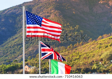 Flags of all nations of the world are flying in blue sunny sky background, Nationals flag blowing wind background.
