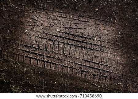 Tyre track on dirt sand or mud, retro tone, grunge tone, drive on sand, off road track Royalty-Free Stock Photo #710458690
