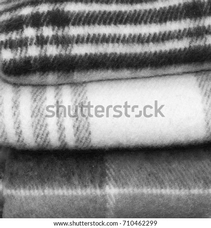 Stack of woolen blankets. Close up. Everything for your warmness. Beautiful photo of a pile of nice light blankets. Black and White photography
