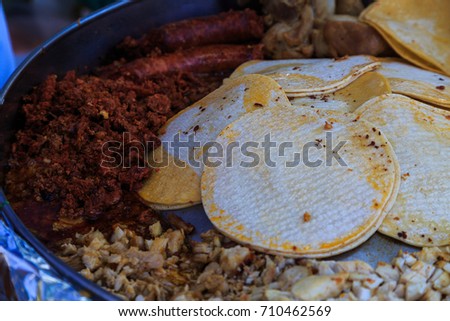 Chorizo, chicken, sausage, onions, tortillas, corn meal all combine to make tacos at a Latin Food festival.