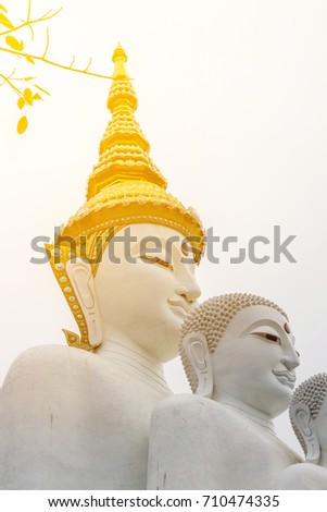 The white sitting Buddha images from small to the biggest image with crown with the white sky in the temple where is a public place and can be taken picture for sell.