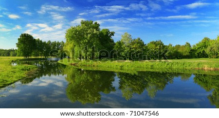 Reflection of trees in the river at dawn Royalty-Free Stock Photo #71047546