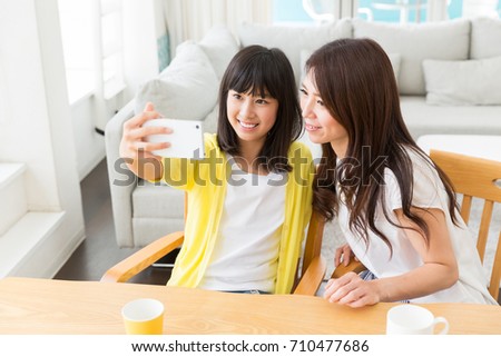  asian parent and daughter,smart phone,selfie