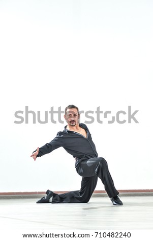 Young and stylish modern dancer on white background