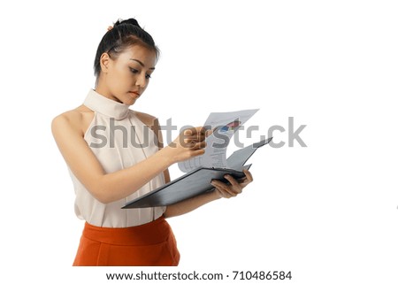 Full length young business woman taking notes on her clipboard isolated on white background