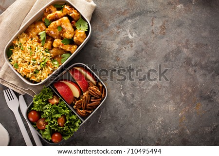 Lunch boxes with food ready to go for work or school, ahead meal preparation or dieting concept Royalty-Free Stock Photo #710495494