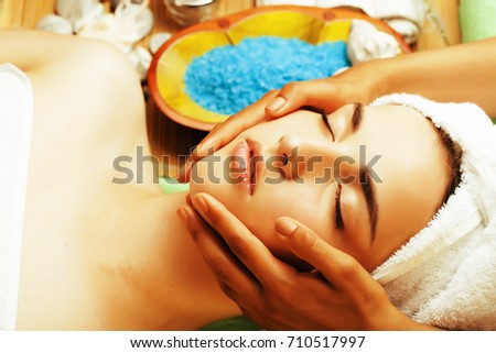 stock photo attractive lady getting spa treatment in salon, close up asian hands on face