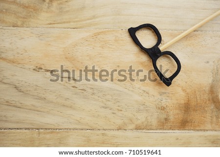 Top or flat lay view of Photo booth props a black spectacles on a wooden background flat lay. Birthday parties and weddings.