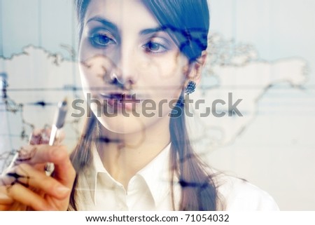A girl with a map of the world printed on a transparent material