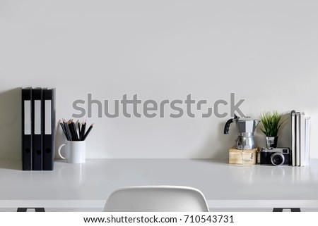 Work space Mock up white tabletop with files, pencils and houseplant. wood desk with copy space for products display montage.