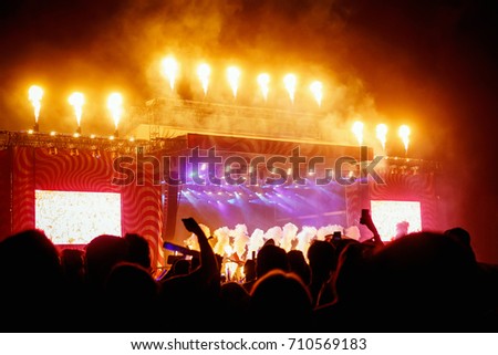 Big concert stage with fire production at outdoor music festival