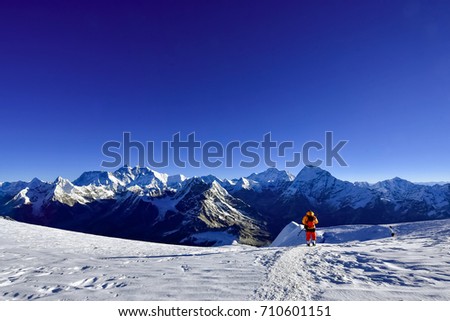  A lone Mountaineer walking down from Mera Peak in front of Mt. Everest, Lhotse ,Makalu, Ama Dablam etc.