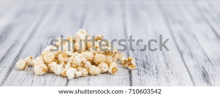 Fresh made Popcorn on a vintage background as detailed close-up shot