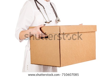 Young doctor holding box. image on a white studio background.