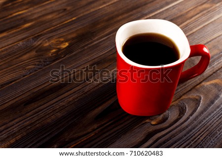 red cup coffee on dark wood background