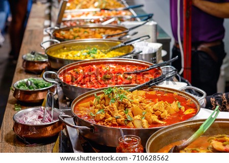 Variety of cooked curries on display at Camden Market in London Royalty-Free Stock Photo #710628562
