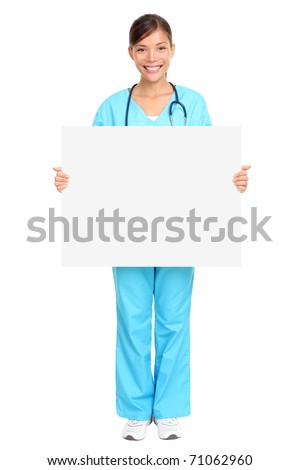 Nurse showing medical sign billboard standing in full length. Young smiling woman nurse or doctor in scrubs showing empty blank sign board with copy space. Asian model isolated on white background.