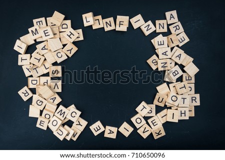 Wooden letters on a black background form a frame
