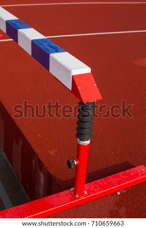 Balance beam on red running stadium background.Gymnastic equipment