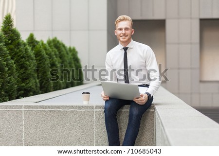 Well dressed happiness businessman working outsourcing, looking at camera and toothy smile. Outdoor Royalty-Free Stock Photo #710685043