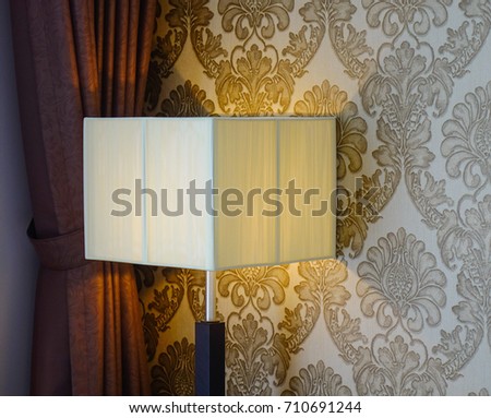 Elegant lamp with yellow light at living room of modern house.