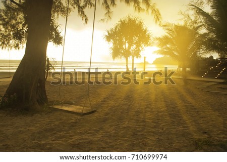 swing with  sunset light at the beach