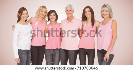 Portrait of smiling women supporting breast cancer social issue against neutral background 