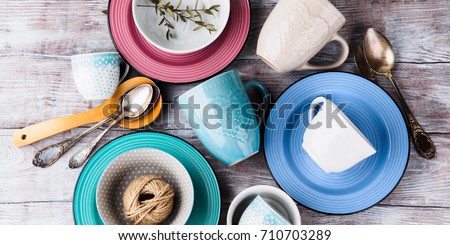 Ceramic crockery tableware on wooden background. Pastel vintage color bowls, dishes, cups Royalty-Free Stock Photo #710703289