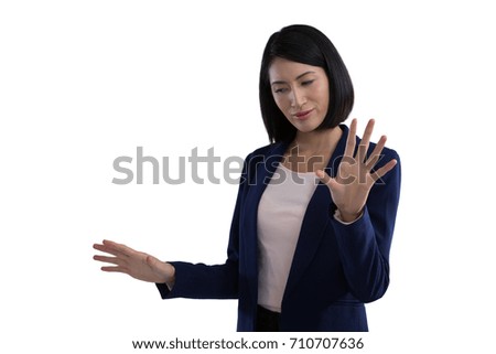 Businesswoman using invisible screen against white background