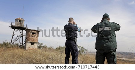 Two border policemen observe border Royalty-Free Stock Photo #710717443