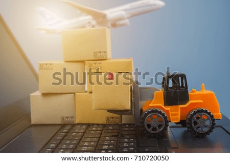 Forklift truck with boxes on a laptop keyboard,Ideas about loading for logistic import export and transport industry concept background.