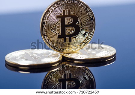 
    Golden bitcoin coins on a dark background with reflection. Virtual currency. Crypto currency. New virtual money