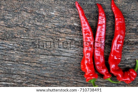 Red hot peppers on wood background. Top view with copy space.