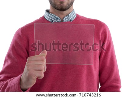 Mid section of man holding glass digital tablet against white background