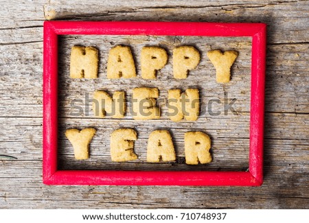 Happy new year note in a frame written with cookies