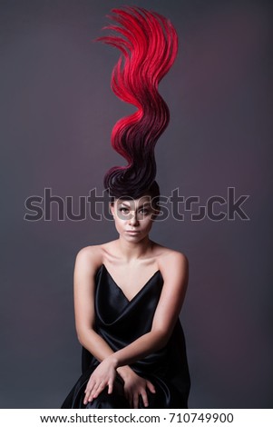 studio portrait of a woman with a fantasy fiery hairdo