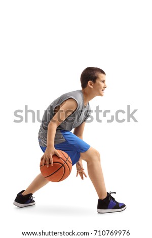 Profile shot of a boy dribbling a basketball isolated on white background