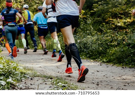 group of runners athletes running in forest trail marathon Royalty-Free Stock Photo #710795653