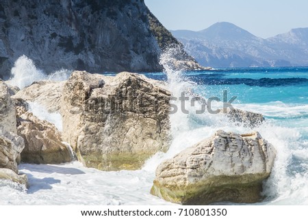 Rough sea and furious waves smack into the rocks at the beach of Cala Goloritzè, Sardinia, Italy.