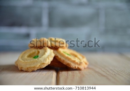 freshly baked butter cookies over the wooden table. Selective focus applied