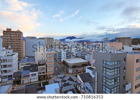 Pictures of big cities and tall buildings with mist floating above the mountains are a beautiful background in the morning at Japan.