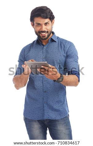 Smart young businessman with tablet computer on white.